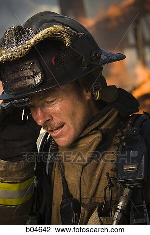 Portrait of a firefighter with fire in background View Large Photo Image Stock Image - Portrait of a firefighter with fire in background. Fotosearch