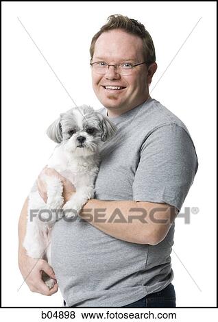 Stock Photo - Portrait of a man with small dog. Fotosearch
