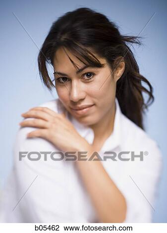 Portrait of a woman posing with hand on shoulder View Large Photo Image Stock Image - Portrait of a woman posing with hand on shoulder. Fotosearch