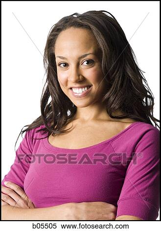 Stock Photography - Portrait of a woman with arms crossed smiling. Fotosearch
