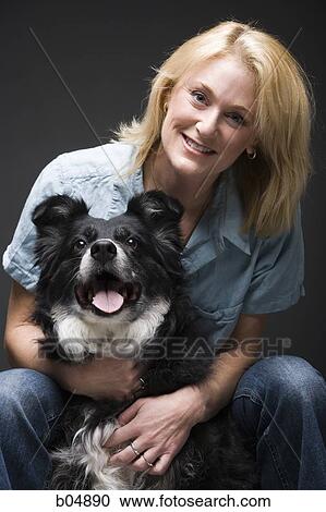 Portrait of a woman with black dog View Large Photo Image Stock Image - Portrait of a woman with black dog. Fotosearch