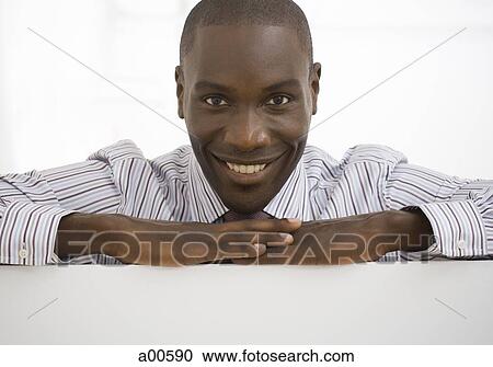 Portrait of a young businessman smiling View Large Photo Image Stock Image - Portrait of a young businessman smiling. Fotosearch
