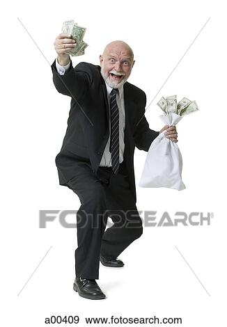 Portrait of businessman holding money and money bag View Large Photo Image Stock Photo - Portrait of businessman holding money and money bag. Fotosearch
