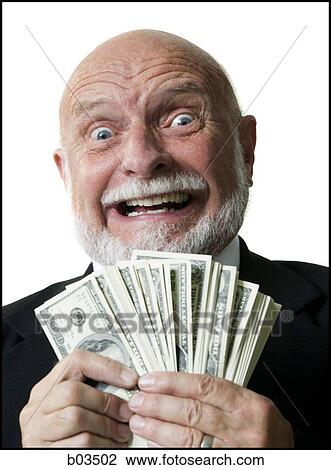 Stock Image - Portrait of businessman holding US banknotes. Fotosearch
