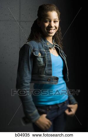 Stock Photography - Portrait of girl smiling in denim jacket. Fotosearch