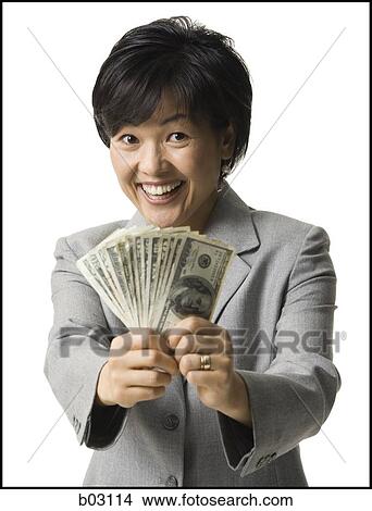Portrait of woman holding US banknotes View Large Photo Image Picture - Portrait of woman holding US banknotes. Fotosearch