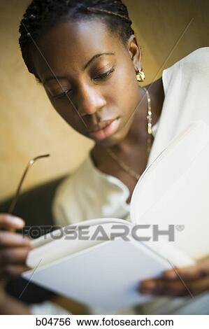 Portrait of woman with glasses reading View Large Photo Image Stock Photograph - Portrait of woman with glasses reading. Fotosearch