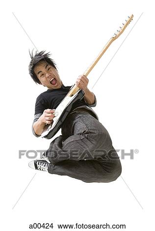 Portrait of young man playing electric guitar View Large Photo Image Picture - Portrait of young man playing electric guitar. Fotosearch