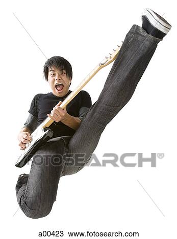 Stock Image - Portrait of young man playing electric guitar. Fotosearch