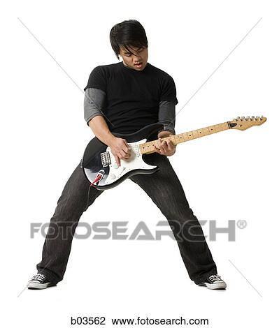 Portrait of young man playing electric guitar View Large Photo Image Stock Image - Portrait of young man playing electric guitar. Fotosearch