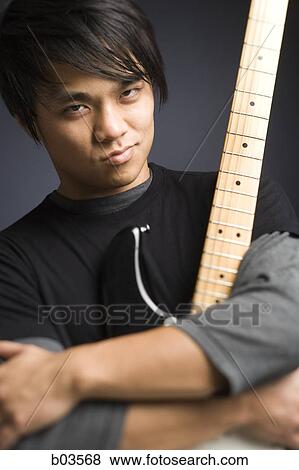 Portrait of young man with electric guitar View Large Photo Image Stock Photo - Portrait of young man with electric guitar. Fotosearch