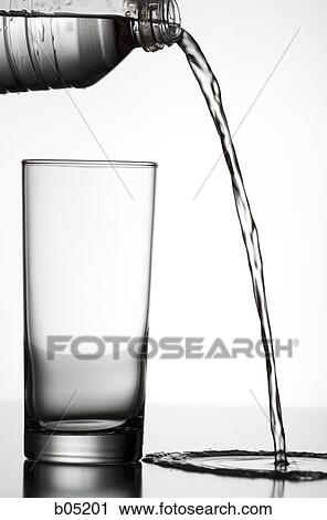 Pouring water beside an empty glass View Large Photo Image Stock Image - Pouring water beside an empty glass. Fotosearch