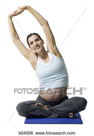 Stock Photo - Pregnant woman doing yoga. Fotosearch
