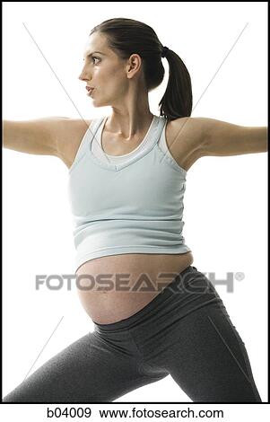Stock Photo - Pregnant woman doing yoga. Fotosearch
