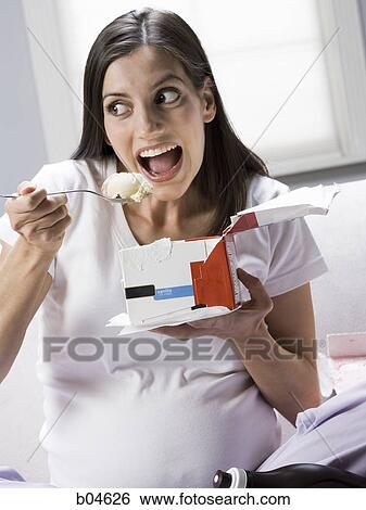 Pregnant woman eating ice cream View Large Photo Image Stock Photograph - Pregnant woman eating ice cream. Fotosearch