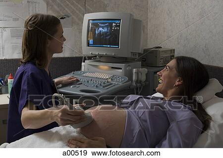 Stock Photo - Pregnant woman having an ultrasound. Fotosearch