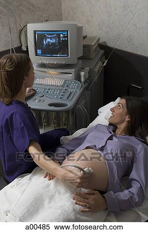 Pregnant woman having an ultrasound View Large Photo Image Stock Photography - Pregnant woman having an ultrasound. Fotosearch