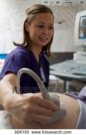 Pregnant woman having an ultrasound View Large Photo Image Stock Photography - Pregnant woman having an ultrasound. Fotosearch