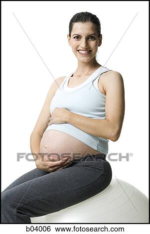 Pregnant woman holding belly and smiling View Large Photo Image Stock Photograph - Pregnant woman holding belly and smiling. Fotosearch