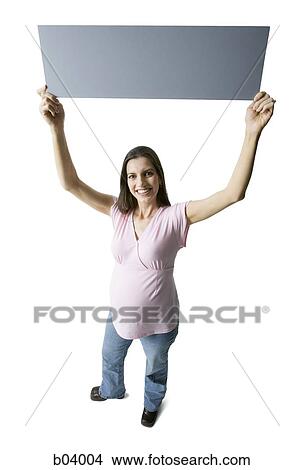 Pregnant woman holding blank sign View Large Photo Image Picture - Pregnant woman holding blank sign. Fotosearch