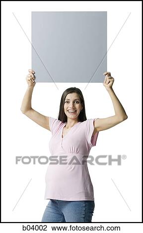 Pregnant woman holding blank sign View Large Photo Image Stock Image - Pregnant woman holding blank sign. Fotosearch
