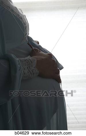 Stock Photo - Pregnant woman in nightgown. Fotosearch