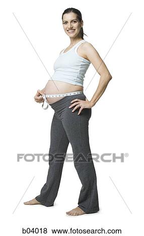 Pregnant woman measuring belly View Large Photo Image Stock Photo - Pregnant woman measuring belly. Fotosearch