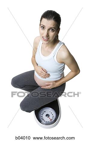 Pregnant woman on scale View Large Photo Image Stock Image - Pregnant woman on scale. Fotosearch