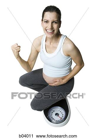 Pregnant woman on weigh scale View Large Photo Image Stock Image - Pregnant woman on weigh scale. Fotosearch