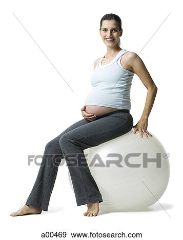 Pregnant woman sitting on pilates ball View Large Photo Image Stock Photo - Pregnant woman sitting on pilates ball. Fotosearch