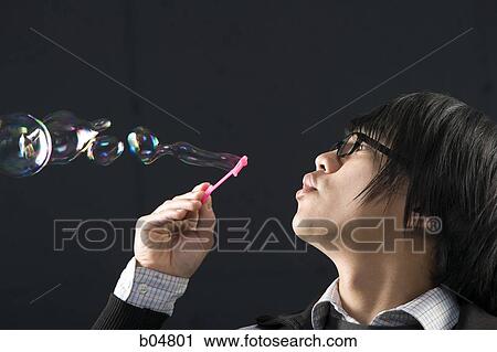 Profile of man with glasses blowing bubbles View Large Photo Image Stock Image - Profile of man with glasses blowing bubbles. Fotosearch