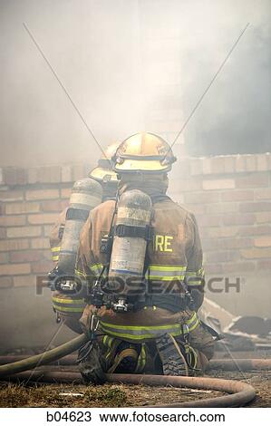 Rear View of firefighter in smoke View Large Photo Image Stock Image - Rear View of firefighter in smoke. Fotosearch