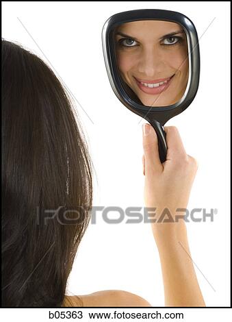 Reflection of woman smiling in hand mirror View Large Photo Image Stock Image - Reflection of woman smiling in hand mirror. Fotosearch