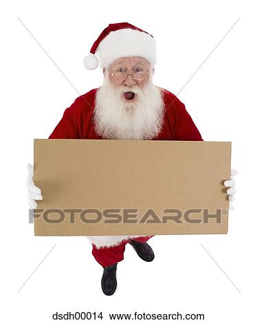 Santa Claus standing and holding a blank sign View Large Photo Image Picture - Santa Claus standing and holding a blank sign. Fotosearch
