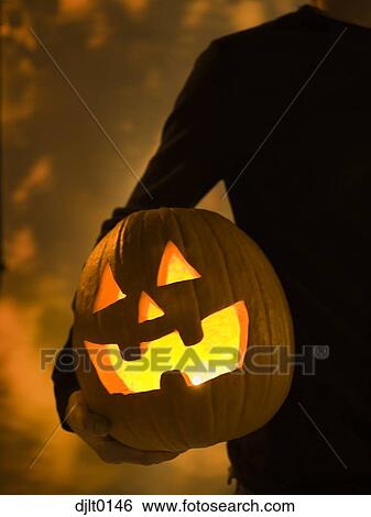 Stock Photograph - Silhouette of man with jack o''lantern. Fotosearch