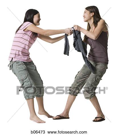 Sisters fighting over clothes View Large Photo Image Stock Image - Sisters fighting over clothes. Fotosearch