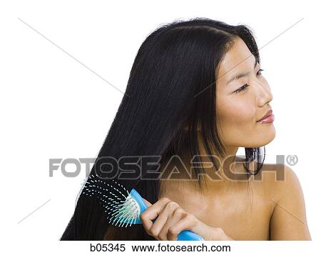 Smiling woman brushing hair View Large Photo Image Stock Photography - Smiling woman brushing hair. Fotosearch