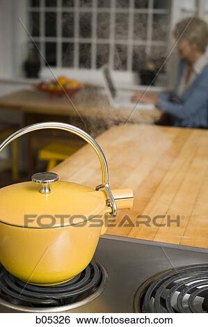 Stock Photograph - Steaming kettle on stovetop. Fotosearch