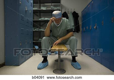 Surgeon in locker room looking distraught View Large Photo Image Stock Image - Surgeon in locker room looking distraught. Fotosearch