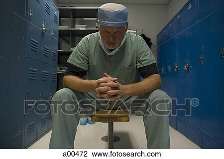 Surgeon in scrubs sitting in locker room View Large Photo Image Stock Image - Surgeon in scrubs sitting in locker room. Fotosearch