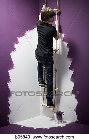 Teenage boy climbing a ladder View Large Photo Image Stock Photo - Teenage boy climbing a ladder. Fotosearch