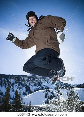 Teenage boy jumping outside in the snow View Large Photo Image Stock Image - Teenage boy jumping outside in the snow. Fotosearch
