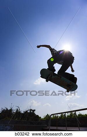 Stock Image - Teenage boy on skateboard. Fotosearch