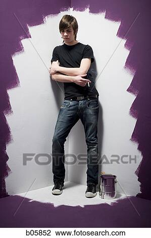 Stock Image - Teenage boy painting smoking a cigarette. Fotosearch