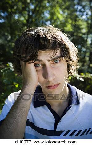 Stock Photo - Teenage boy rubbing head. Fotosearch