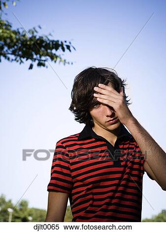 Stock Photography - Teenage boy rubbing head. Fotosearch
