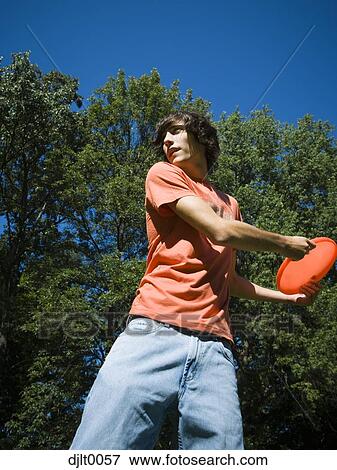 Stock Photo - Teenage Boy tossing a Frisbee. Fotosearch