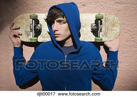 Stock Photo - Teenage boy with skateboard. Fotosearch