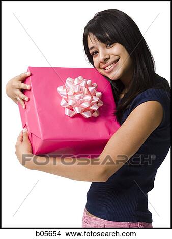 Teenage girl holding a gift View Large Photo Image Picture - Teenage girl holding a gift. Fotosearch