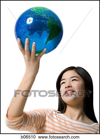 Teenage girl standing with a globe View Large Photo Image Stock Image - Teenage girl standing with a globe. Fotosearch